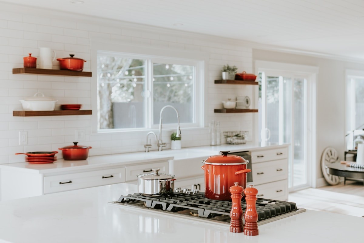 Kitchen island with pendant lights and hardwood floors